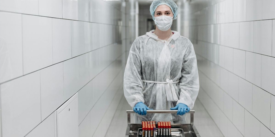 Lab assistant carrying sample tubes