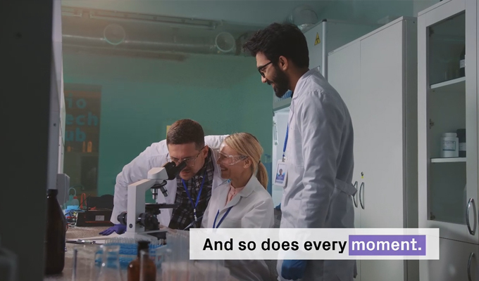 Lab staff using a microscope, illustrating automation solutions from Azenta Life Sciences