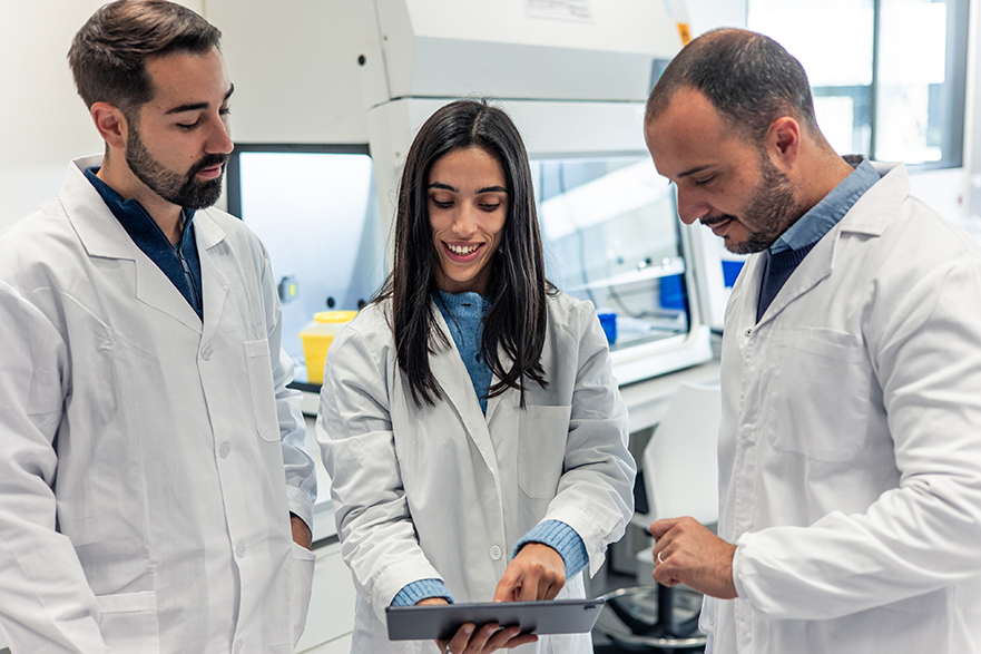 Scientists working together using a tablet in laboratory