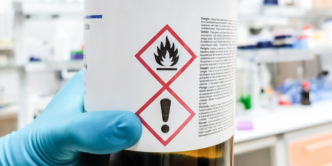 Bottle of chemical liquid with warning label